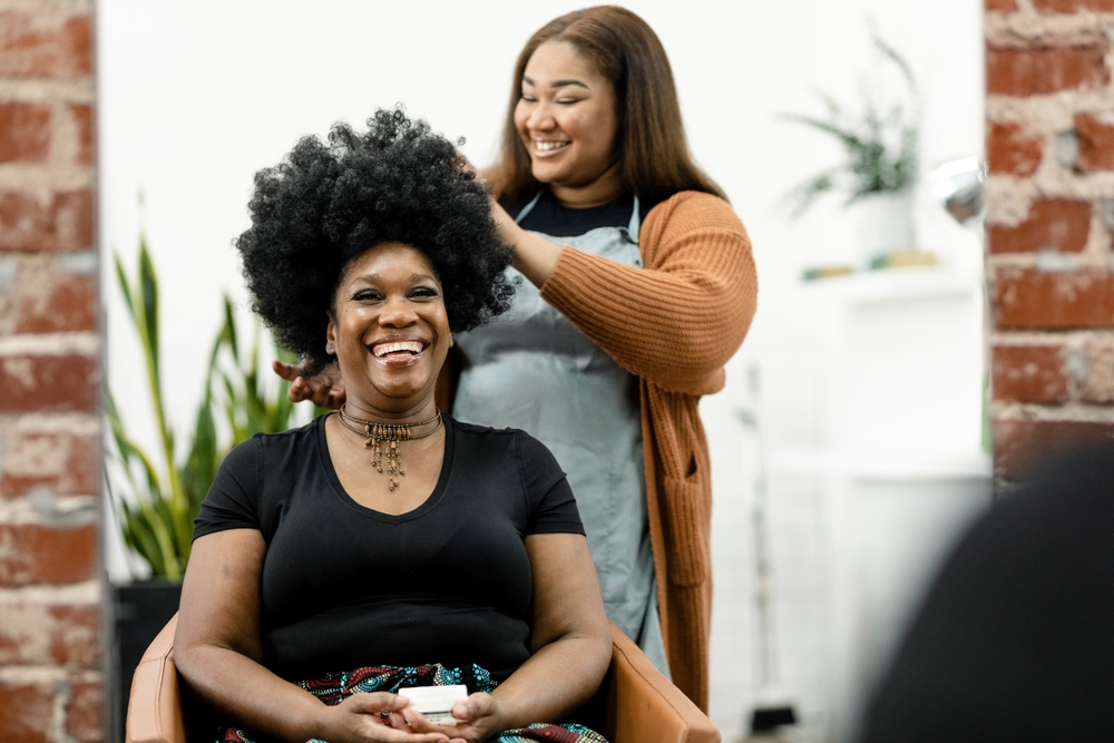 Best Salon Management Software. Person getting hair done in stylist chair. 